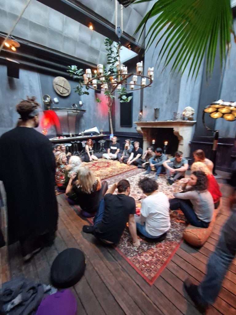 Participants seated in a circle during a workshop in an atmospheric venue